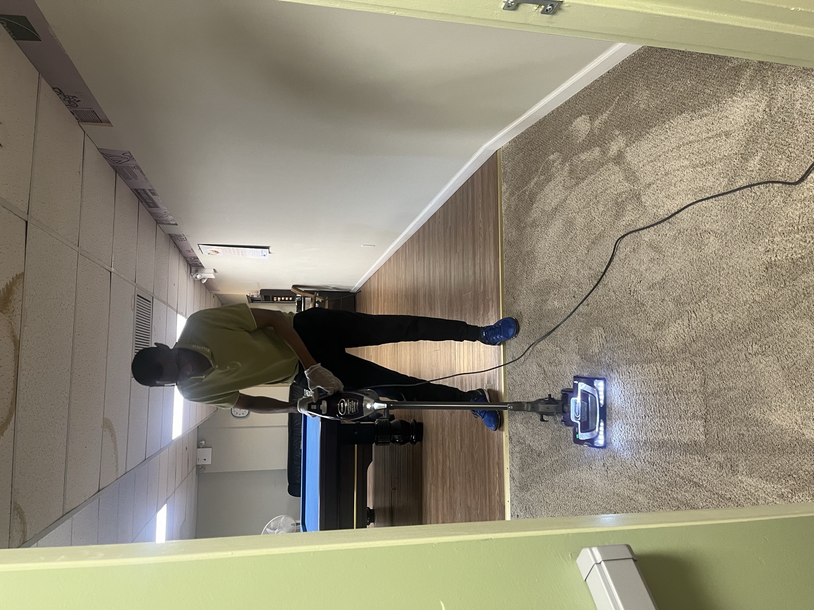 Medina crew member machine-cleaning a floor in shoe covers