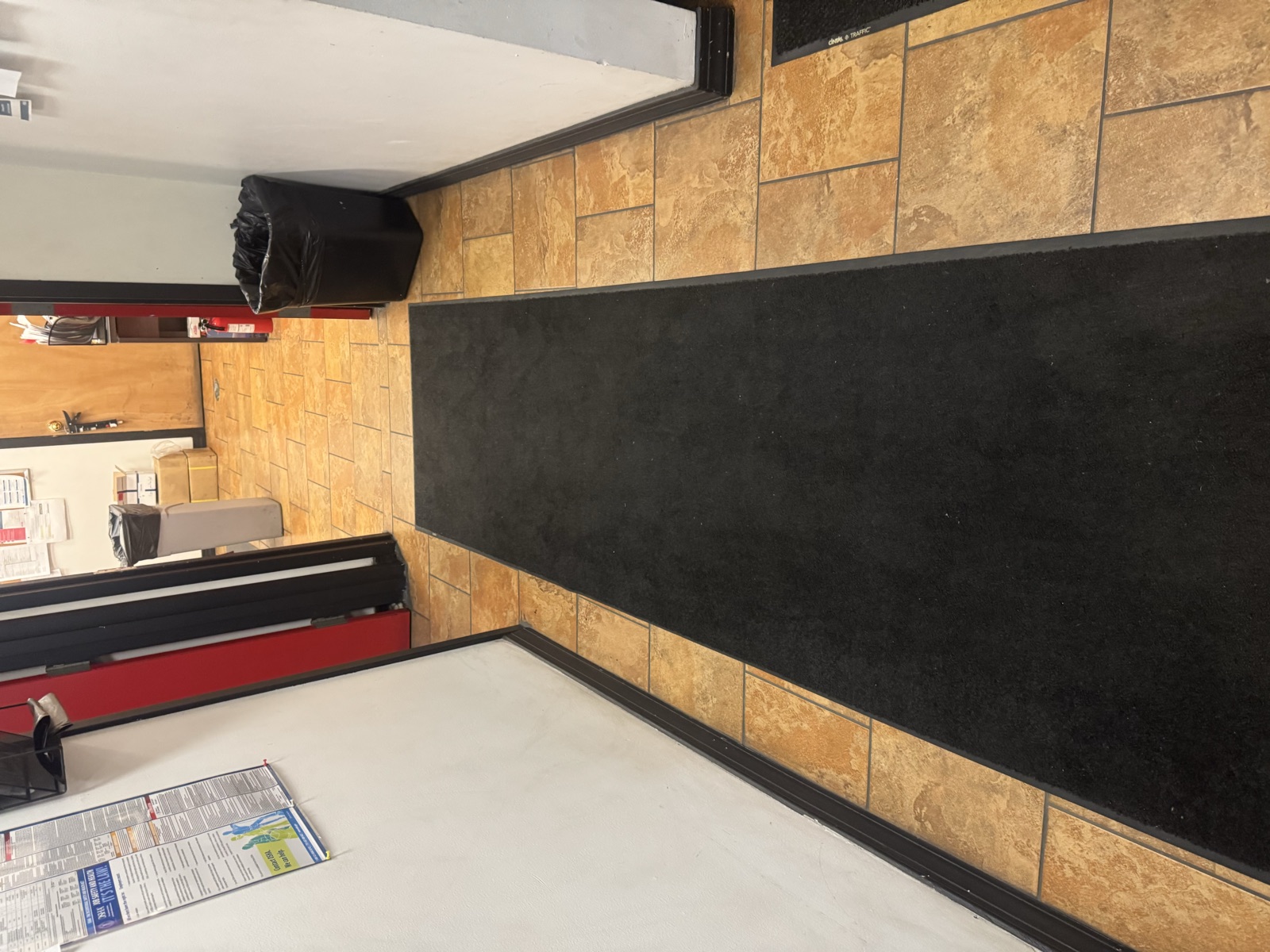 Freshly cleaned tile floor with runner mats in a commercial space
